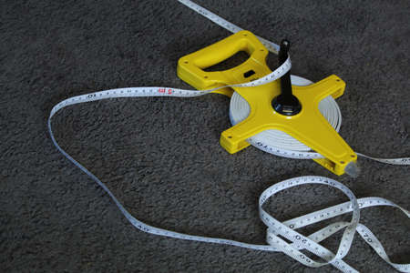 Measuring tape on floor, closeup. Space for textの写真素材