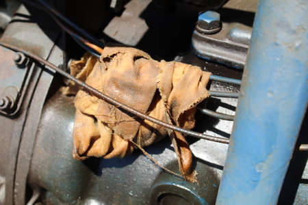 The old engine of an old car is covered with a protective glove