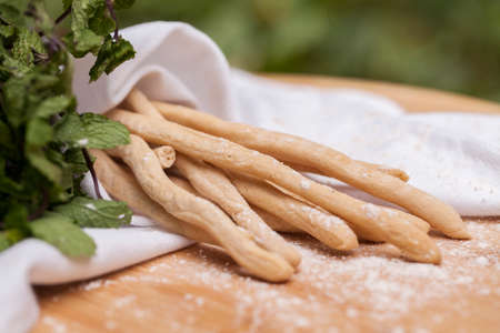 Grissini (Thin Bread Sticks) on wooden cutting board