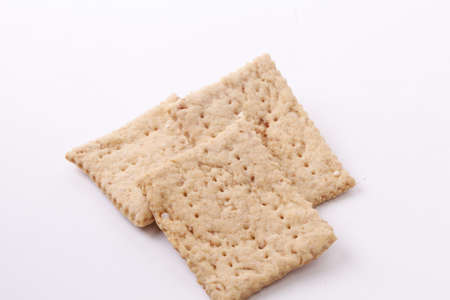 Tasty crispy crackers cookies isolated on white backgroundの写真素材