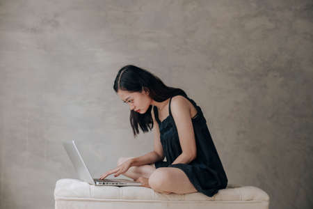 Asian beautiful woman thinking idea with laptop computerの写真素材
