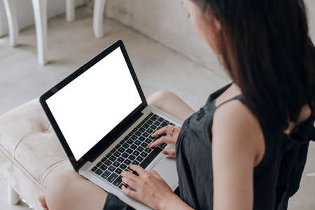 Young women working on her laptop with blank copy space screen for your advertising
