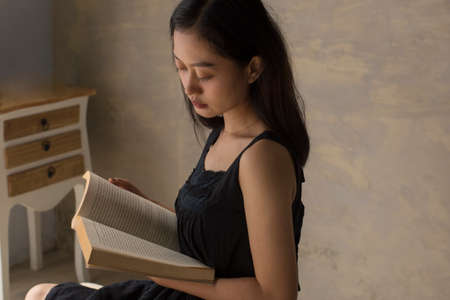 beautiful asian woman reading a book