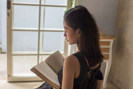 beautiful asian woman reading a book