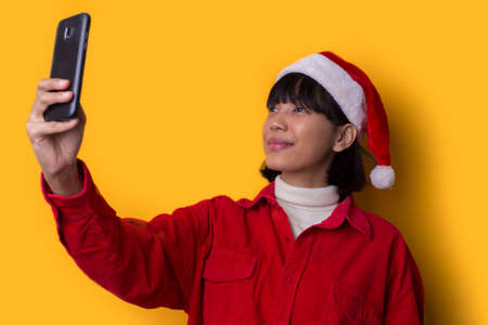 Portrait beautiful asian women wear santa christmas hat taking selfie