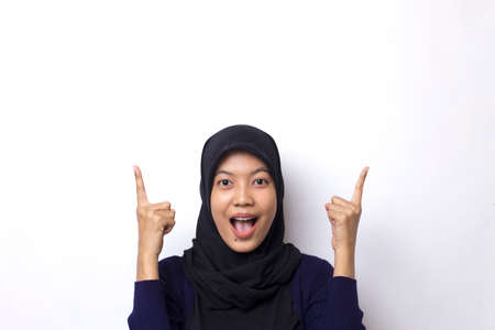 Young asian beautiful woman wearing hijab on white background smiling confident pointing with...