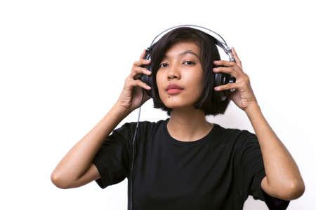 Asian woman listening to music studio shot isolated on white background