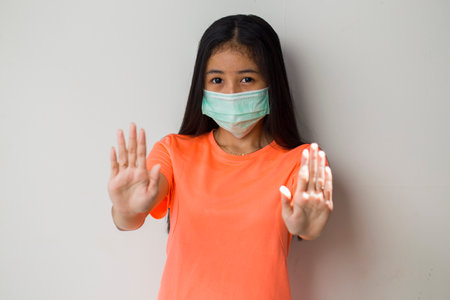 Sporty asian girl wearing medical face mask for protection  virusの写真素材
