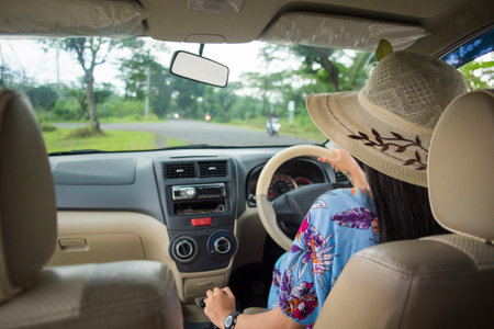 portrait of young asian woman driving a carの写真素材