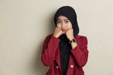 Portrait of a young asian muslim woman thinksの写真素材