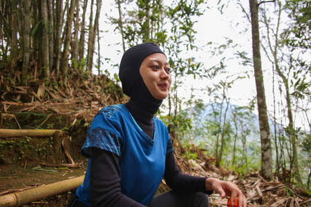 Asian muslim woman drinking water after jogging,healty and sport concept.の写真素材