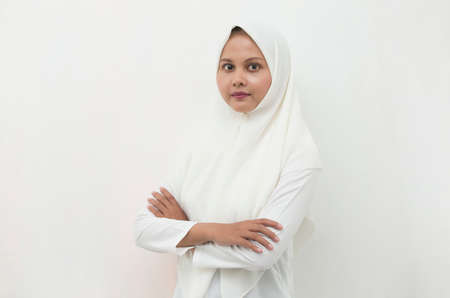 Young asian muslim woman in head scarf smile with arms crossedの写真素材