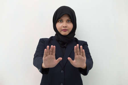 Asian muslim hijab woman show stop hands gestureの写真素材