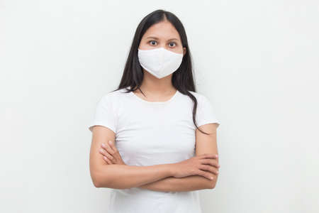 asian girl wearing medical face mask to protection posing on the gray backgroundの写真素材