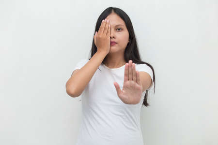 Asian woman making stop gesture with her handの写真素材