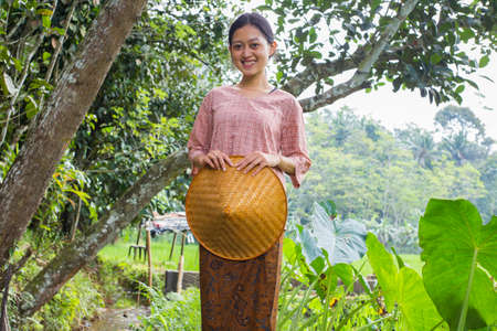 portrait young asian female farmer in rice fieldの写真素材