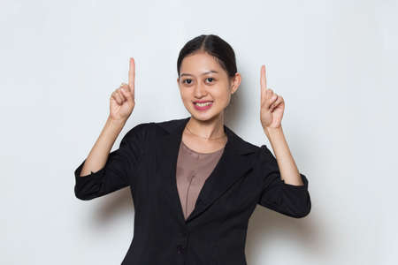 Young asian business woman  smiling confident pointing with fingers to different directions