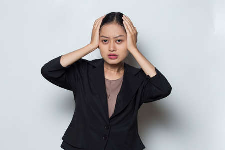 portrait of stressed sick business woman with headache on white backgroundの写真素材