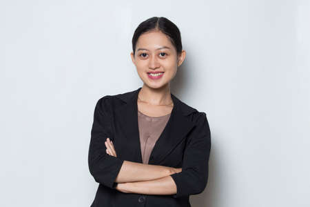 Young asian business woman smile with arms crossedの写真素材