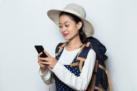 Asian woman tourist speaking on the smartphone isolated on white background