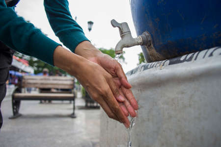Closeup of woman washing hands in public areaの写真素材