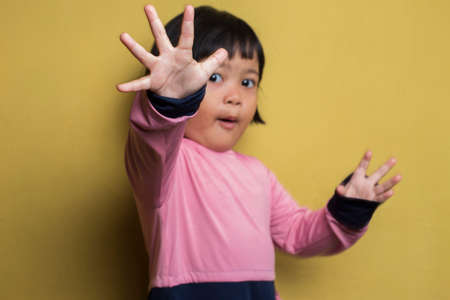 Asian little girl making stop gesture with her handの写真素材