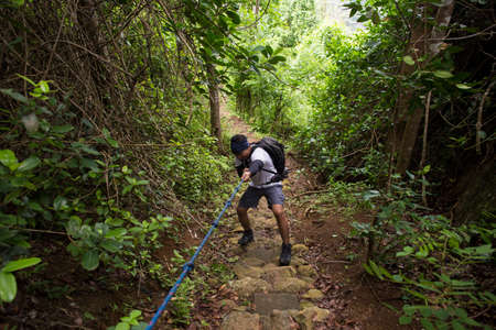 One backpacker man travel alone, with backpack in the mountainsの写真素材