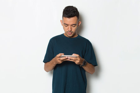 happy young man playing game mobile phone isolated on white background