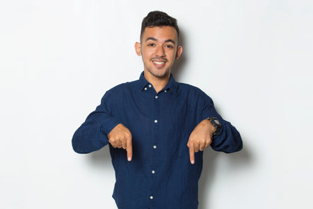 young handsome business man pointing finger on empty space isolated on white backgroundの写真素材