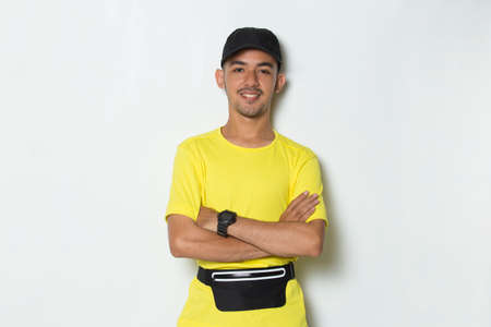 portrait young sporty man dressed in yellow tshirt on white backgroundの写真素材