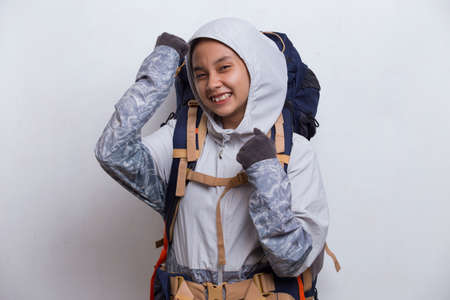 Young beautiful hiker asian woman with a backpack making strong gesture isolated on white backgroundの写真素材