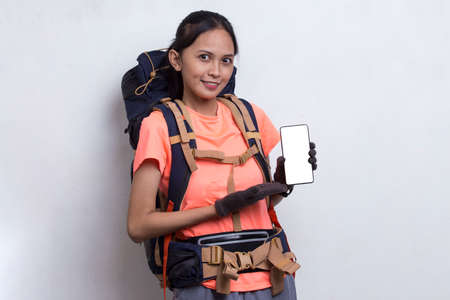 Young asian hiker woman showing mobile phone isolated on white background