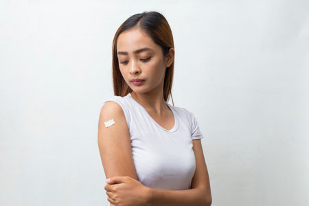 Asian Patient woman Getting Vaccinated Against Coronavirus Receiving Covid Vaccine isolated on white...