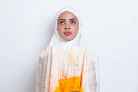 Young asian muslim woman praying isolated on white background
