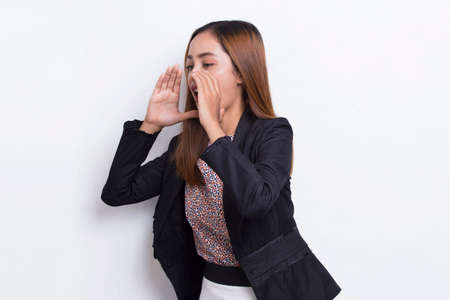 young asian business woman shouting and yelling announcing isolated on white backgroundの写真素材