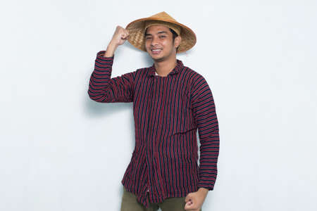 excited happy asian farmer isolated on white backgroundの写真素材