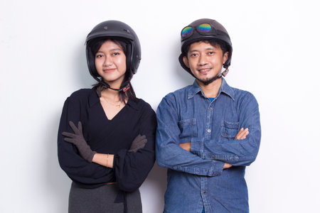 Portrait young asian couple with a motorcycle helmet isolated on white backgroundの写真素材