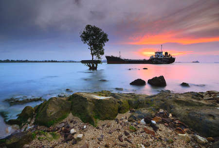 Tangker and barge in sunset on beach Batam island