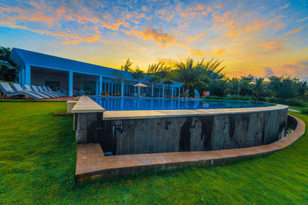 Batam, Indonesia - December
 09 2018 Enjoy the beautiful Sunrise at Haris Resort Barelang with lounge chairs by the poolのeditorial素材