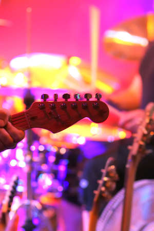 Close up stage shot of man playing guitar