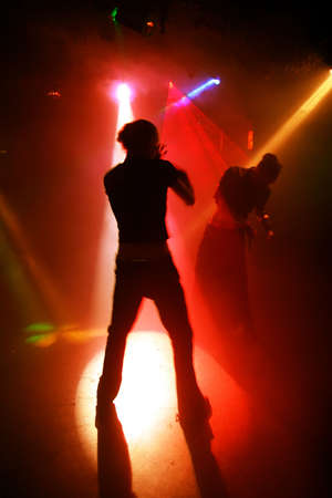Silhouettes of a dancing teenagers in a disco