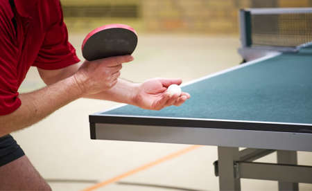 Table tennis player doing a serve, close-upの写真素材