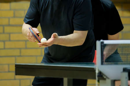Table tennis player doing a serve, close-upの写真素材
