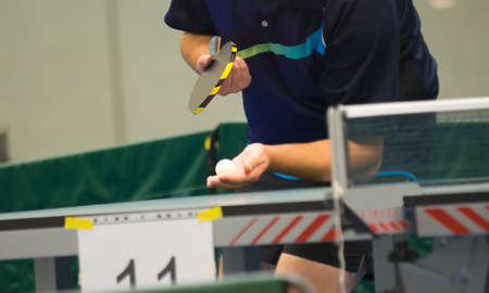 Table tennis player doing a serve, close-upの写真素材