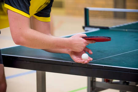 Table tennis player doing a serve, close-upの写真素材