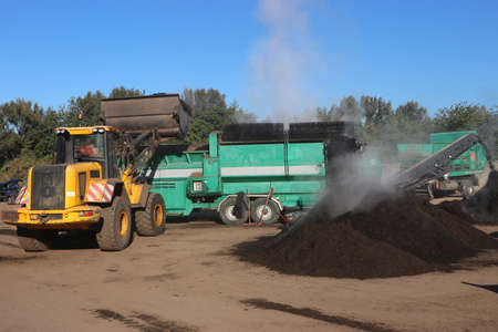 Wheel loader working in a composting facility for biowaste, green waste and sewage sludge. The...