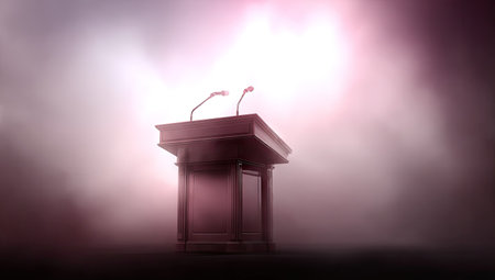 Dark, wooden podium stands on a stage in a misty setting, lit by dramatic spotlights. Two microphones are positioned atop the podium.の素材