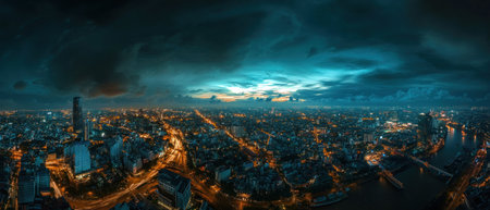 The night view of the cityscape in Ho Chi Minh City, Vietnam is illuminated by modern buildings and streets, with an impressive river flowing through it. The sky above shows dark clouds adding to its dramatic beauty. Shot on a Canon EOS R5 mirrorless camera using a wide-angle lens, the image captures the vibrant lights illuminating the skyline against the backdrop of blue hues. This aerial shot provides a panoramic perspective showcasing the intricate details of urban life. --ar 7:3 --v 6.1 Job ID: 80f40086-33f9-4cf0-81f4-baa808e51edcの素材