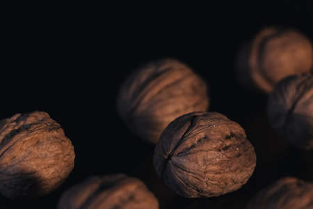 walnuts on a black background, you can see a cracked walnut, selective focus.の写真素材