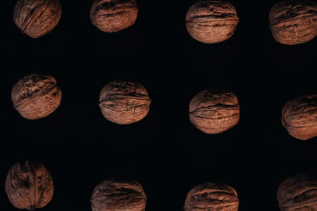 walnuts on a black background, you can see a cracked walnut, selective focus.の写真素材